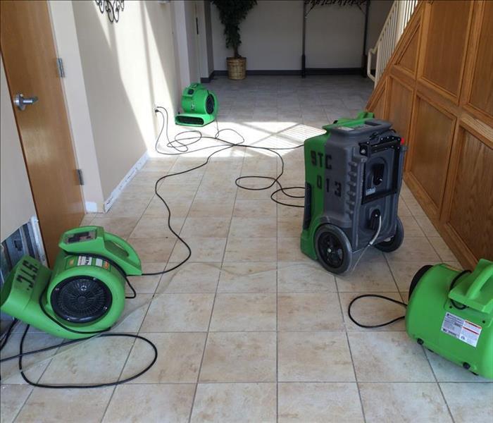 Four green drying machines in a hallway