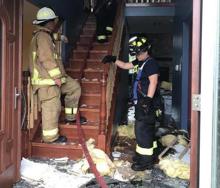 Firemen in staircase with fire