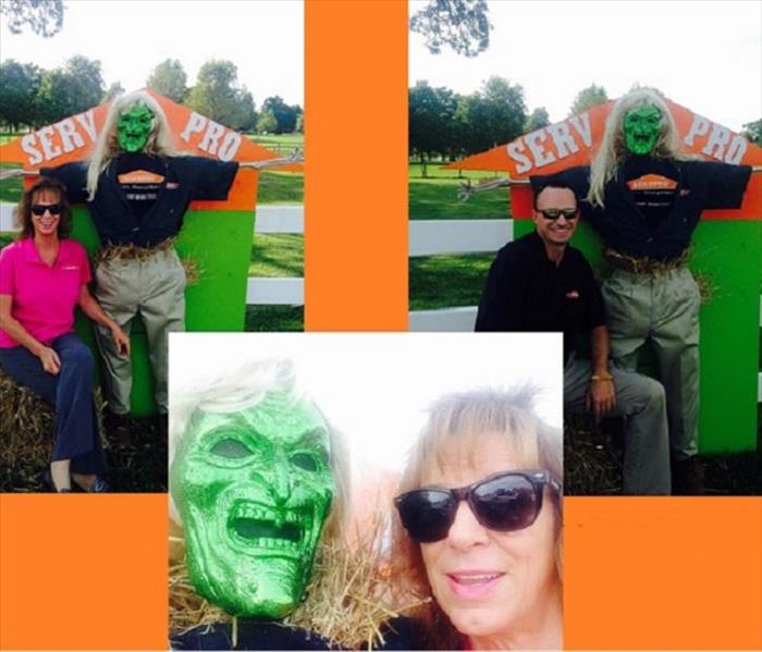 Male and female SERVPRO representatives with SERVPRO scarecrow